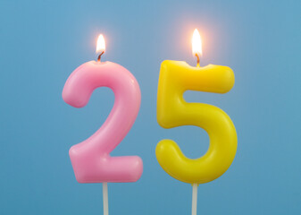 Birthday candles on blue background, number 25