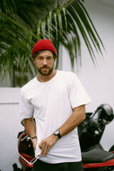 Young handsome man surfer in sunglasses and white t-shirt.