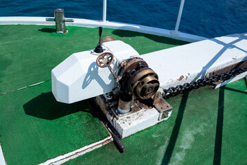Anchor lifting mechanism engine on the boat. Anchor chain winch mechanism.