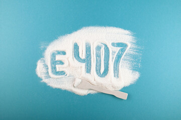 Inscription E407 of Carrageenan Gum Powder on blue background. Refined Carrageenan. Food additive...