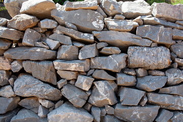 Old stone wall texture background. Rough stone wall. Big rough stones fence.