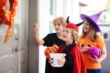 Kids trick or treat. Halloween. Child at door.