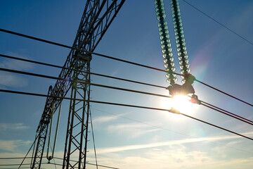 High voltage tower with electric power lines divided by safe guard bushing transfening safely...