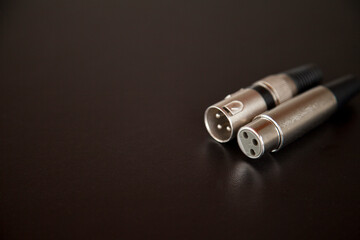 xlr audio cable on top of a black table. Connections on display. xlr cable concept. audio concept.