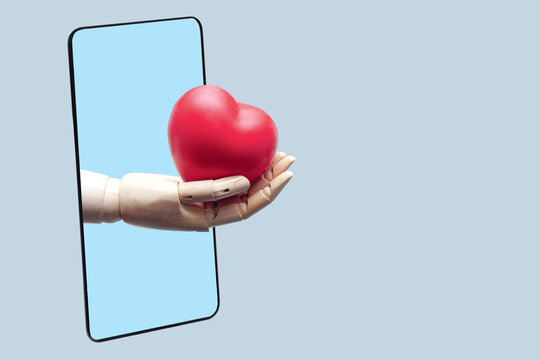The robot hand gives red heart from black smartphone, connected to online technology communication. Medical Technology and future concept.