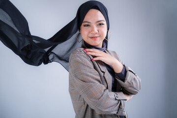 Portrait of a beautiful female Muslim model wearing hijab, a lifestyle apparel for Muslim women isolated from background. Modern hijab fashion concept.