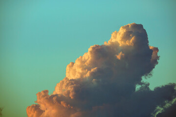 White fluffy cumulonimbus clouds forming before thunderstorm on evening sky. Changing stormy...
