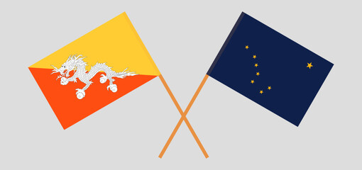 Crossed flags of Bhutan and the State of Alaska. Official colors. Correct proportion