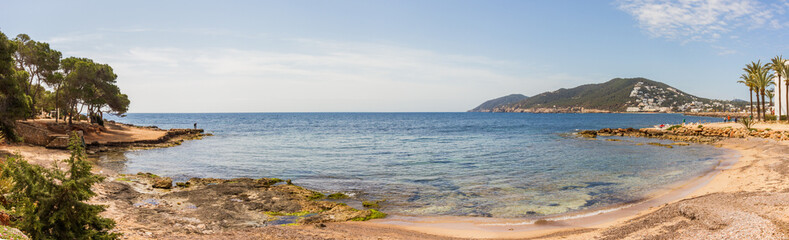 Fototapeta na wymiar Small hidden beach with pine trees at Santa Eulalia del Rio, Ibiza island, Balearic islands, Spain