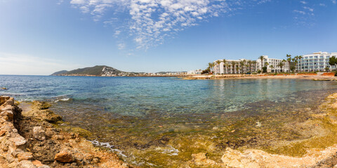 Rocky coast and clear, shallow Mediterranean sea at Santa Eulalia del Rio, Ibiza island, Balearic islands, Spain