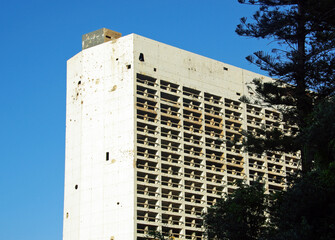 Ruin of a former hotel with bullet and mortar holes in Beirut, Lebanon