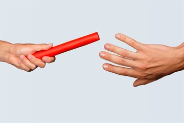 Sport person hands passing a baton during run