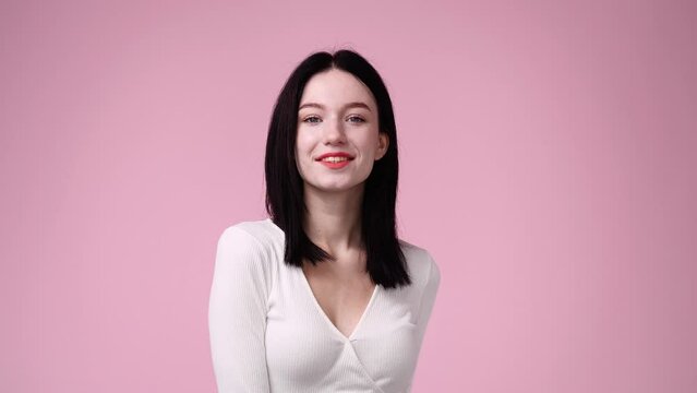 4k video of positive woman on pink background.