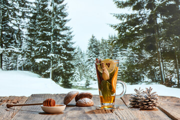 Design for wallpaper. Autumn or winter still life with hot tea with fruit, berries and spices in glass cup. Healthy active lifestyle, holidays, liric or romantic mood