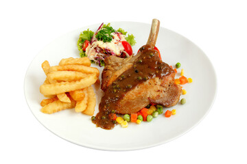 Grilled pork chop steak with french fries and vegetables butter and black pepper sauce.