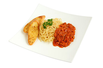 Spaghetti on white plate with rich tomato and meat sauce with salad and garlic bread.