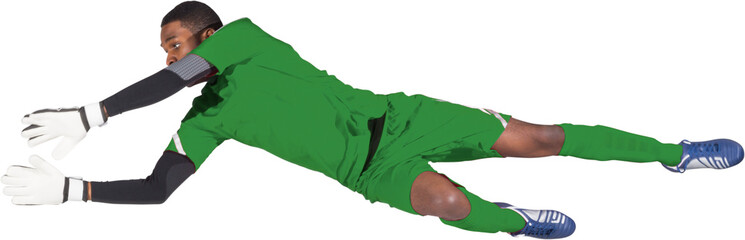 Image of african american male football goalkeeper in green strip diving to block the goal - Powered by Adobe