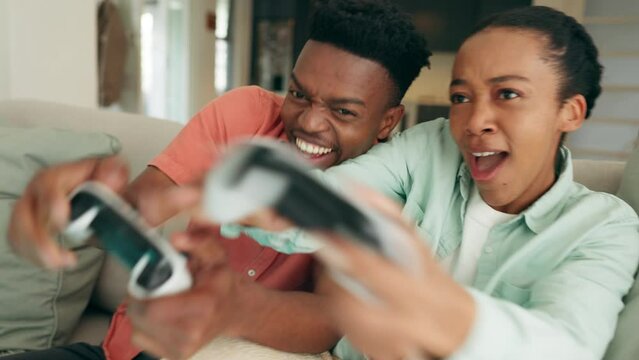 Couple, video game and excited gaming in home lounge for crazy, relaxing and happy day together. Young, laughing and funny black people playing console controller, games challenge and entertainment