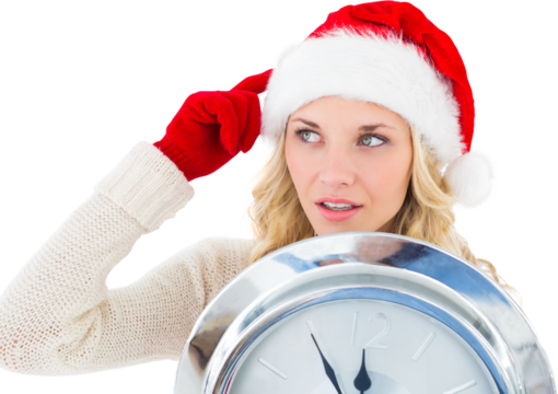 Image of caucasian woman in christmas santa hat holding clock