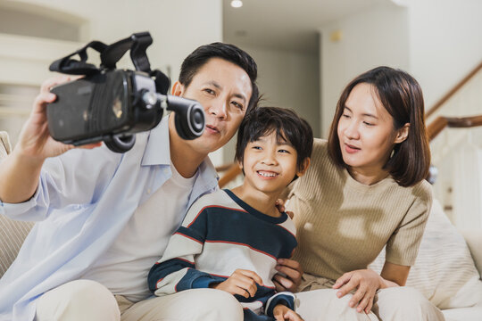 Happy Asian family are wearing VR to playing game