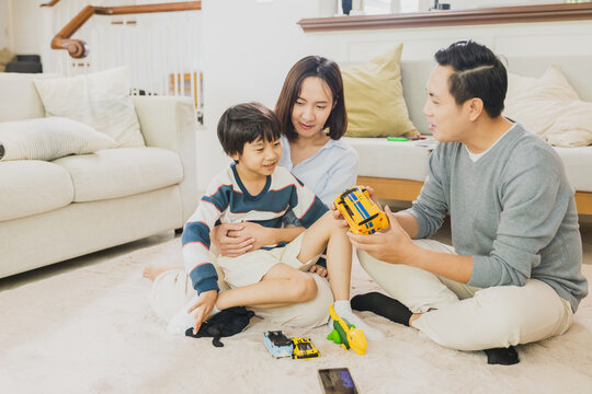 happy family playing with son at home 