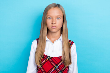 Photo of small young schoolgirl wear new uniform serious september sale shopping isolated on blue...
