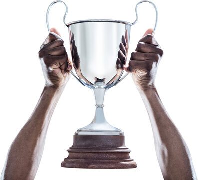 Image of hands of african american man holding up silver trophy cup