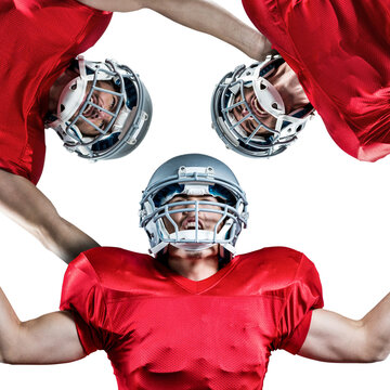Image of three smiling diverse american football players in helmets standing in circle