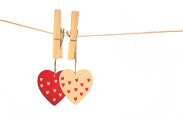 Image of two wooden hearts hanging on pegs on string
