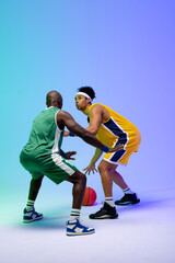 Image of two diverse basketball players with basketball playing on purple to green background