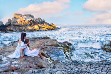 mother and daughter on the ocean.