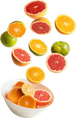 fresh citrus fruits falling into a bowl
