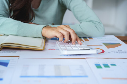 female employee using a calculator to calculate financial documents