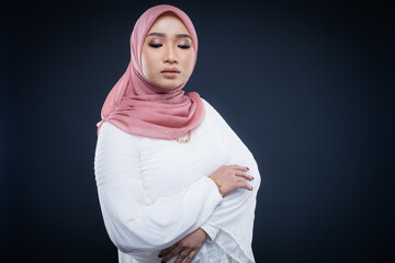 Portrait of a beautiful female Muslim model wearing hijab, a lifestyle apparel for Muslim women isolated. Modern hijab fashion concept.