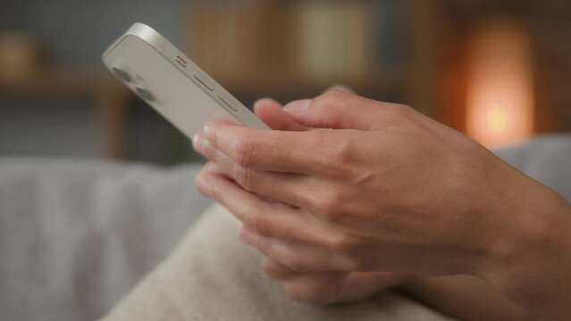Closeup Caucasian female hands holding modern smartphone at home chatting with friends in social network online chat internet purchase browse web download new freeware tech application on mobile phone