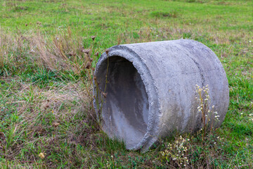 Concrete rainwater well pipe in a field