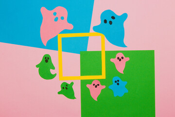 colorful ghosts on a colorful background, in the middle of the frame as copy space, creative halloween concept
