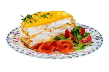 Scrambled eggs layered with salmon and fresh vegetables. Breakfast.