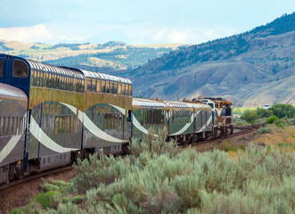 Rocky mountaineer locomotive with gold and silver leaf train wagons near Kamloops, British Columbia, Canada.