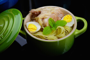 Homemade soup with chicken and quail egg. Homemade food. Beautiful background. Rustic.