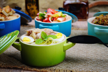 Homemade soup with chicken and quail egg. Homemade food. Beautiful background. Rustic.