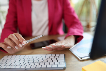 Business woman at workplace sawing nails with nail file