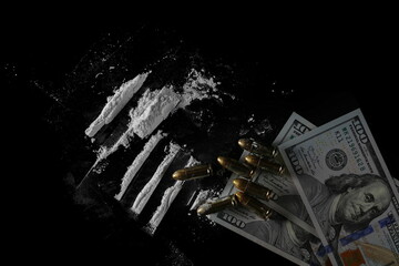 Hundred dollars, pistol bullets  and cocaine lines isolated on black  