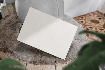 Clean minimal A5 flyer mockup floating on timber background with leaves