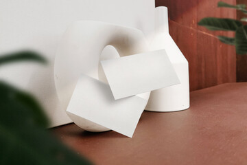 Clean minimal business card mockup floating on table with plant