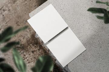Clean minimal square flyer mockup on top marble with leaves