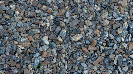 Gravel is a small rock, usually derived from crushed granite. Small in size, usually used for the construction of buildings and roads.