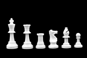 White chess pieces are isolated on a black background
