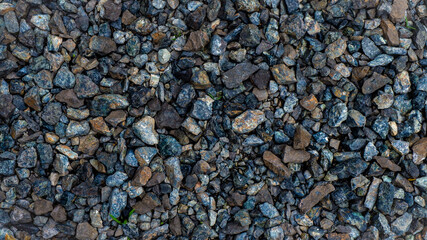 Gravel is a small rock, usually derived from crushed granite. Small in size, usually used for the construction of buildings and roads.