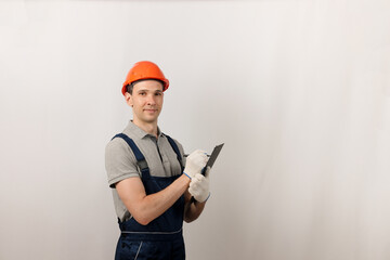 Repair work and construction concept. Male construction worker with clipboard.